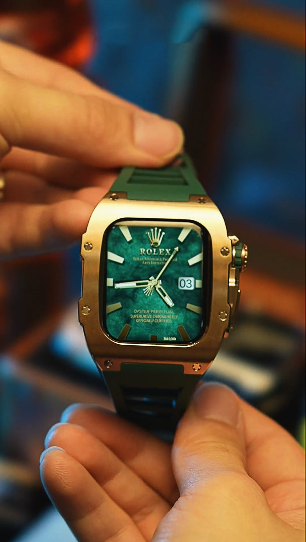 A Man holding an Apple Watch which had applied Kewusuma Titan Series - Golden Titan Titanium Apple Watch Case with a Rolex Watch Face